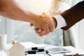 Close up above view of Businessman and client shaking hands after contract agreement done deal. Royalty Free Stock Photo