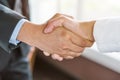 Concept signing business contract, Close up above view of Businessman and client shaking hands after contract agreement done deal. Royalty Free Stock Photo