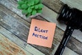 Concept of Silent Auction write on sticky notes with Gavel isolated on Wooden Table