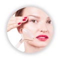 Face lift anti-aging treatment with jade roller. Woman with perfect skin of her face after massage Royalty Free Stock Photo