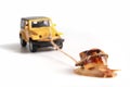 The concept of a sluggish business. The snail Achatina pulls on the trailer car Royalty Free Stock Photo
