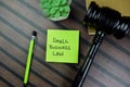 Concept of Small Business Law write on sticky notes with gavel isolated on Wooden Table Royalty Free Stock Photo