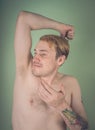 Guy sniffs his armpits Royalty Free Stock Photo