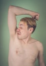 Guy sniffs his armpits Royalty Free Stock Photo