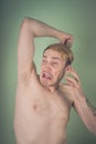 Guy sniffs his armpits Royalty Free Stock Photo