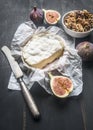 Concept snacks for wine, camembert cheese, fresh sliced figs, vintage table knife, on rustic wooden dark background Royalty Free Stock Photo