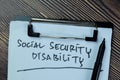 Concept of Social Security Disability write on paperwork isolated on Wooden Table Royalty Free Stock Photo