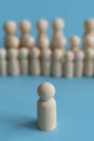 The concept of society. Stand out from the crowd, not like everyone else, leadership. Standing Out From The Crowd. Wooden figures Royalty Free Stock Photo