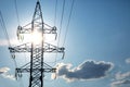 The concept of a source of electricity. Energy industry. High voltage tower with power wires against the background of the sun and Royalty Free Stock Photo