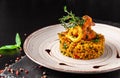 Concept of Spanish cuisine. Paella with seafood, shrimps, squid and greens. Beautiful serving in restaurant