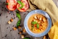 Concept of Spanish cuisine. Tomato soup Gazpacho from fresh tomatoes. Beautiful serving dishes in a blue plate on a wooden table Royalty Free Stock Photo