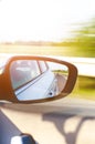 Concept of speed. Car driving on the road. Reflection in a car mirror.Rear view mirror reflection. Blurry background. Royalty Free Stock Photo