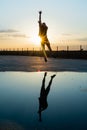 Concept: sport. Athlete man outdoors. Moving silhouette of person jumping. Sunset with epic sky