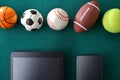 Concept of sports events and technology with devices and balls Royalty Free Stock Photo