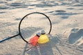 The concept of sports games and summer recreation. Beach badminton. Racket and two shuttlecocks on the sand at sunset