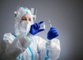 Detail closeup of syringe needle and ampoule , nurse taking injection shot,hands in blue protective gloves holding