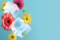 Concept of Spring. Creative composition of falling flowers and ice cubes on a blue background Royalty Free Stock Photo