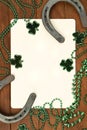 Concept of St. Patrick. green clover necklaces and lucky horseshoes with poker cards on wooden background, top view Royalty Free Stock Photo