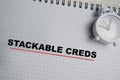 Concept of stackable creds write on book isolated on Wooden Table Royalty Free Stock Photo