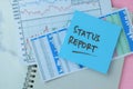 Concept of Status Report write on sticky notes isolated on Wooden Table Royalty Free Stock Photo