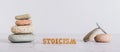 Concept stoicism word made from letters and pyramid of stones on gray background web banner