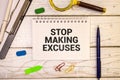 Concept of Stop Making Excuse write on a book isolated on Wooden Table. Selective focus on Stop Making Excuse text Royalty Free Stock Photo
