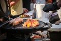 The concept of street food. Outdoor fast food restaurant in park. Roast kebab meat and grilled vegetables. The chef in Royalty Free Stock Photo