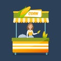 Seller boiled corn behind counter. Sweet corn street food cart. Royalty Free Stock Photo