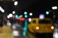 Concept of street and taxi blurred at night with bokeh of lights. NYC, USA Royalty Free Stock Photo