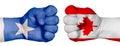 Two hands are clenched into fists and are located opposite each other. Hands painted in the colors of the flags of the countries.