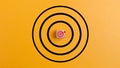 Concept of success. Target with a target icon on a wooden block on a yellow background the concept of achieving or targeting