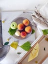 Still life of peaches, apples, leaves on a light background, top view Royalty Free Stock Photo