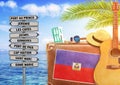 Concept of summer traveling with old suitcase and Haiti town sign