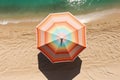 The concept of summer vacation. Top view on a sun lounger under an umbrella on the sandy beach Royalty Free Stock Photo