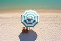 The concept of summer vacation. Top view on a sun lounger under an umbrella on the sandy beach Royalty Free Stock Photo