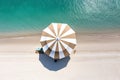 The concept of summer vacation. Top view on a sun lounger under an umbrella on the sandy beach Royalty Free Stock Photo