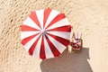 The concept of summer vacation. Top view on a sun lounger under an umbrella on the sandy beach Royalty Free Stock Photo