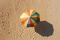 The concept of summer vacation. Top view on a sun lounger under an umbrella on the sandy beach Royalty Free Stock Photo