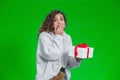 Amazing female is completely surprised to receive such a present. She covers her mouth with hand, eyes widely opened. Royalty Free Stock Photo