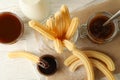 Concept of sweet lunch with churros on white wooden background