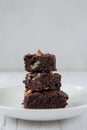 The concept of sweetness, useless food. Pyramid of three pieces of chocolate brownie Royalty Free Stock Photo