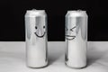 Concept of talking friends. Smile and laugh emoji. dialog of two aluminium cans on black background. Emotions Royalty Free Stock Photo