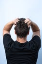 The concept of a problematic situation or depression. A man holding his head on a monochrome background