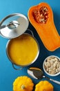 Concept of tasty food with pumpkin soup on blue background Royalty Free Stock Photo