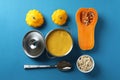 Concept of tasty food with pumpkin soup on blue background Royalty Free Stock Photo