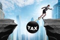 Concept of tax burden with businesswoman over chasm