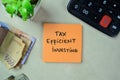 Concept of Tax Efficient Investing write on sticky notes isolated on Wooden Table