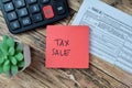 Concept of Tax Sale write on sticky notes isolated on Wooden Table Royalty Free Stock Photo
