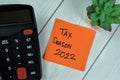 Concept of Tax Season 2022 write on sticky notes isolated on Wooden Table