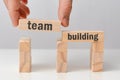 Concept of team building - hand holds a wooden block with the inscription Royalty Free Stock Photo